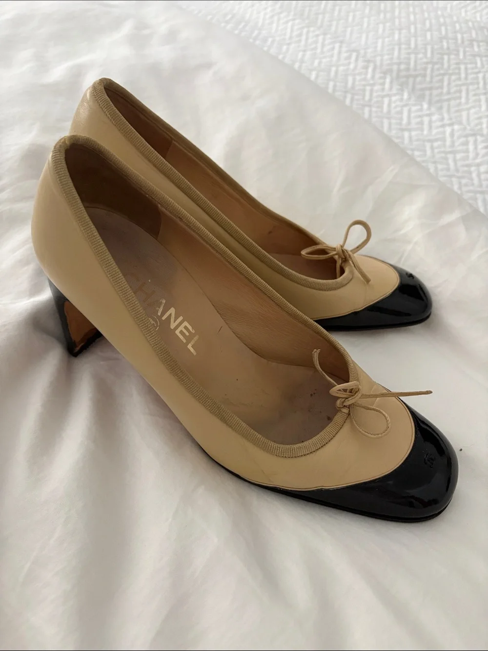 CHANEL Beige and Black Cap-Toe Bow Mid-Heel Pumps